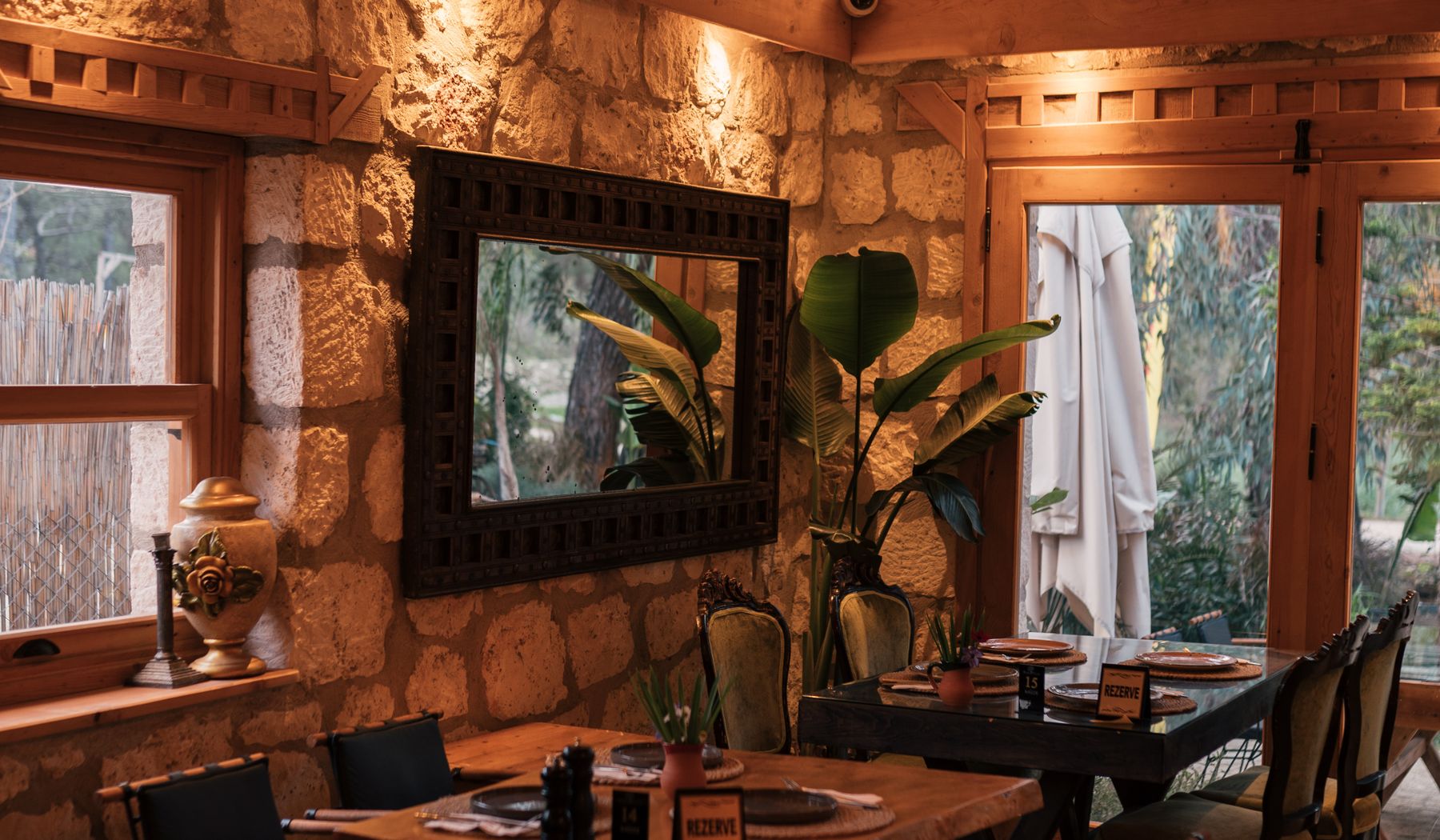 Stone and timber dining room with tables set